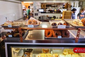 Display case filled with fresh pastries and baked goods in a bakery.
