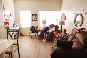 A warmly lit room interior with comfortable seating and personal decor.