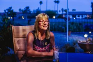 Evening outdoor scene with blue twilight ambiance and patio lighting.