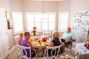 Bright indoor dining area with multiple windows and casual seating arrangements.