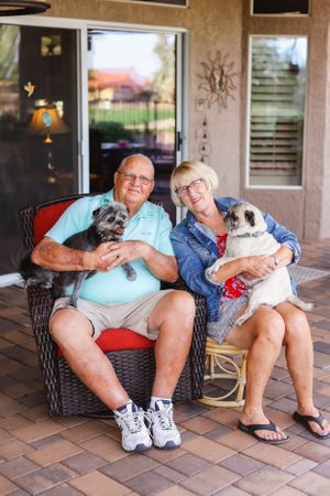 Two people sit together on outdoor patio furniture enjoying a relaxing moment.