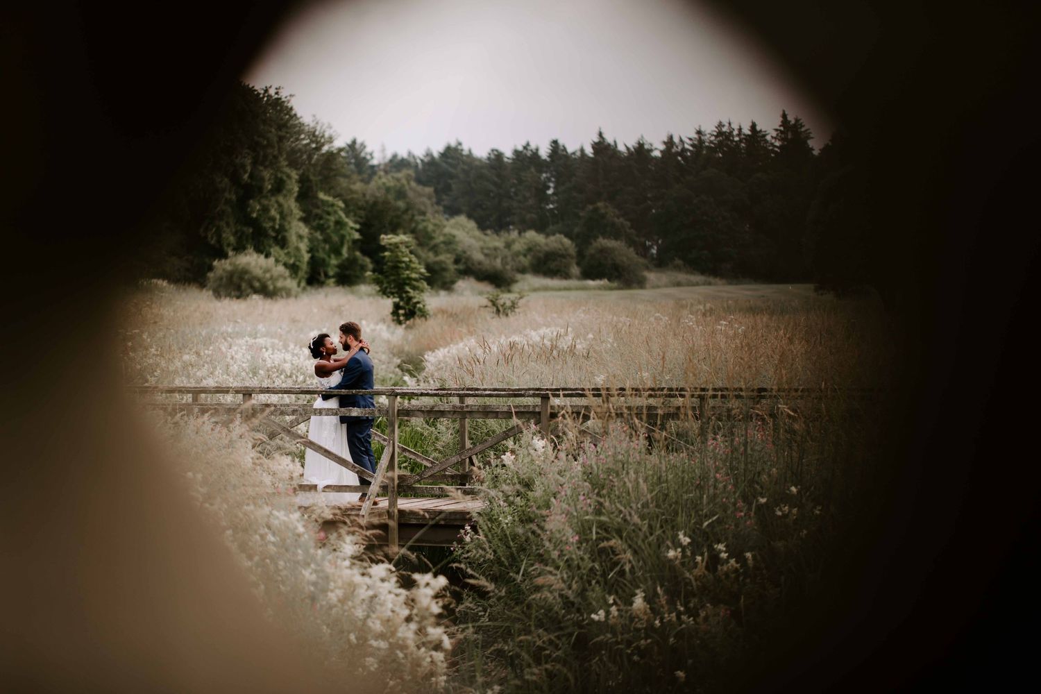 Couple at Matfen Hall, Newcastle, posing over a foot bridge