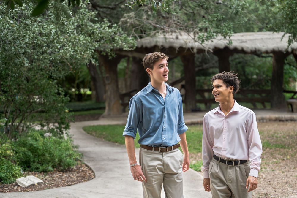 Teen brothers walking and laughing in Landa Gardens at Landa Library