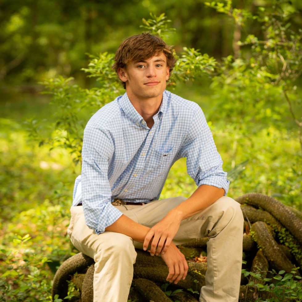 Male senior photo on tree trunk Johns Island