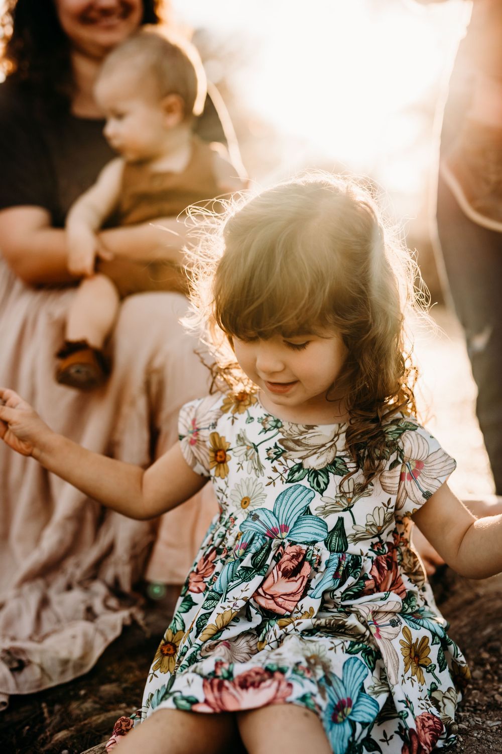 little girl with sun shining behind her