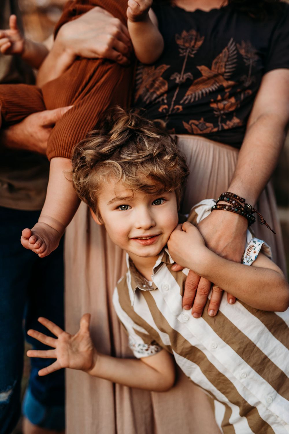 little boy holding his moms hand