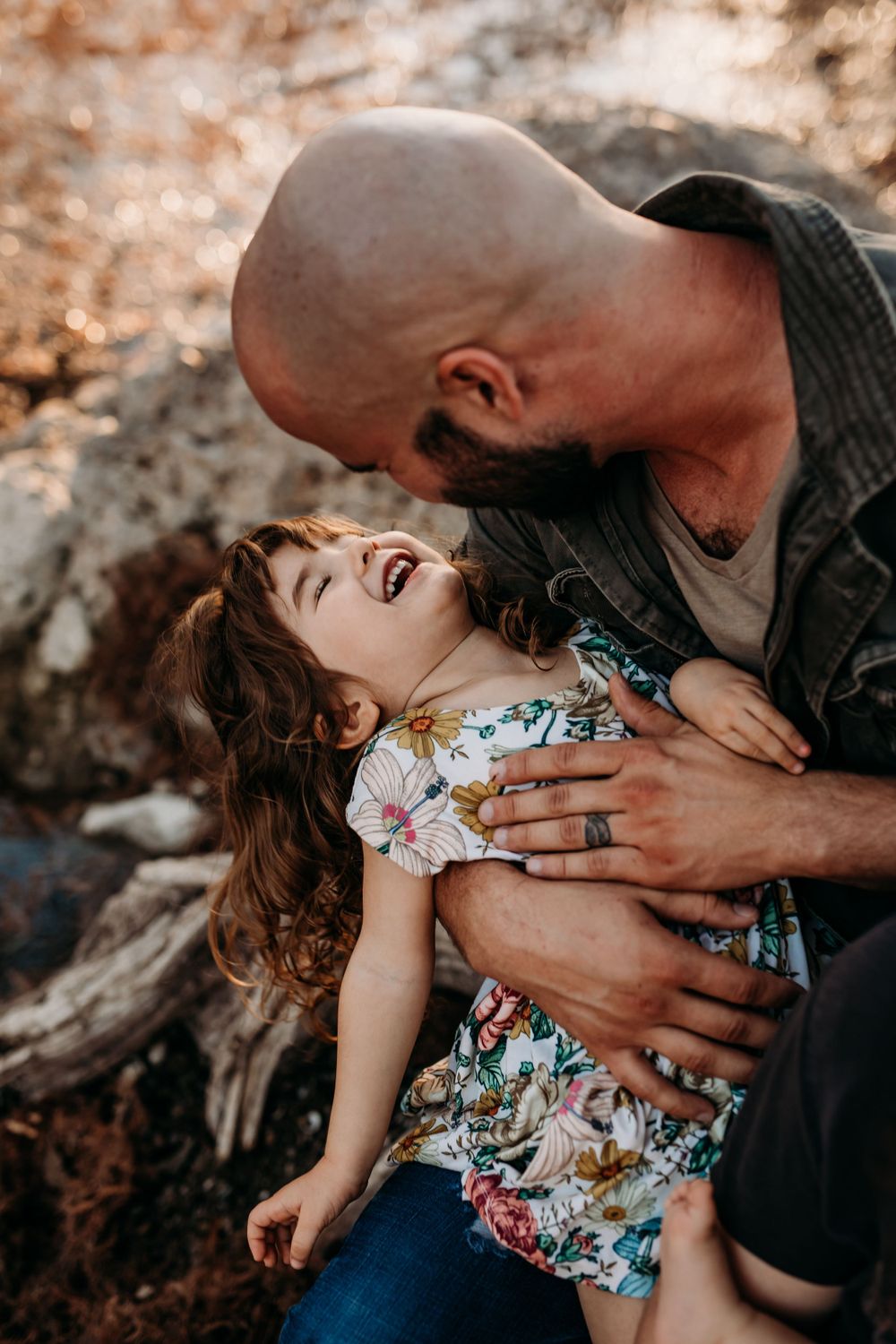 Dad being playful and tickling his daughter