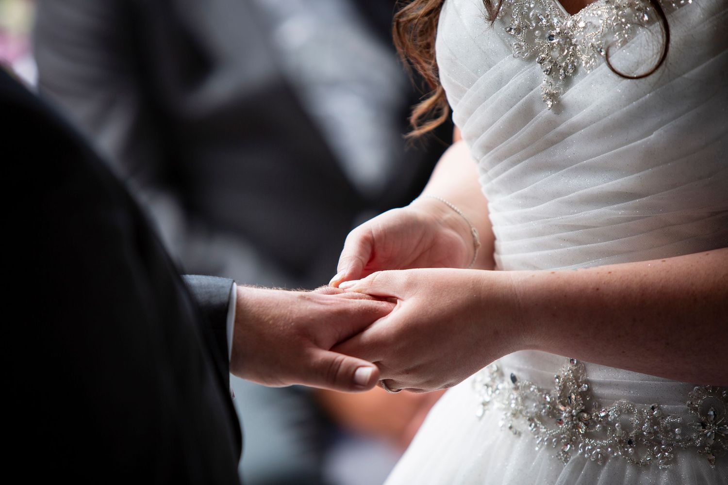 Elegant white wedding dress with intricate beaded detail and sweetheart neckline.