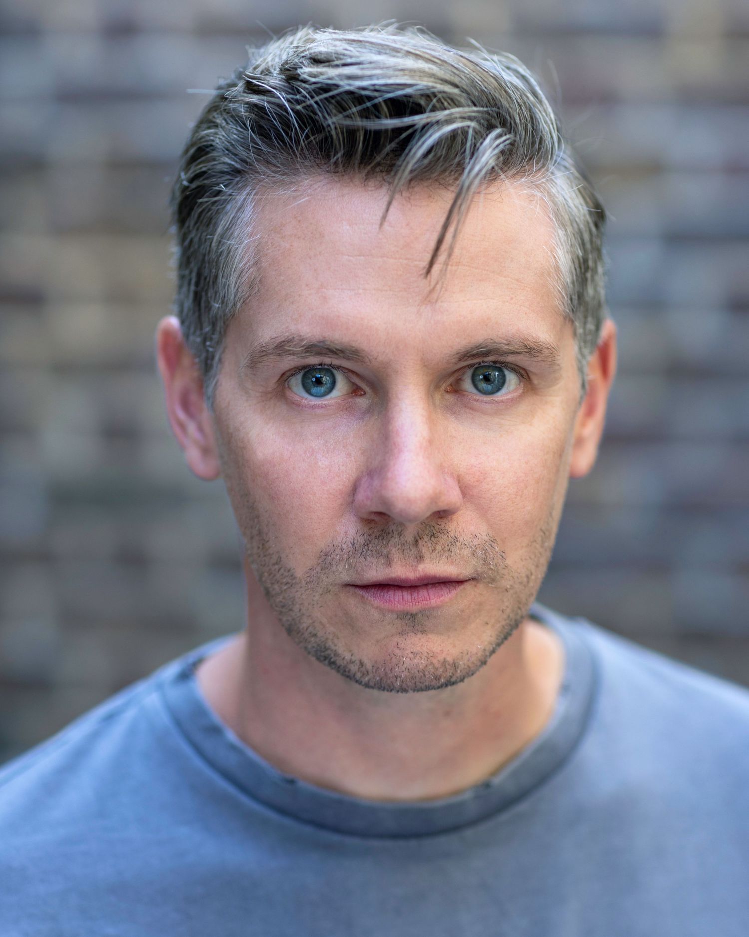 Actor Karl Davies looking into camera with piercing blue eyes for his acting headshot