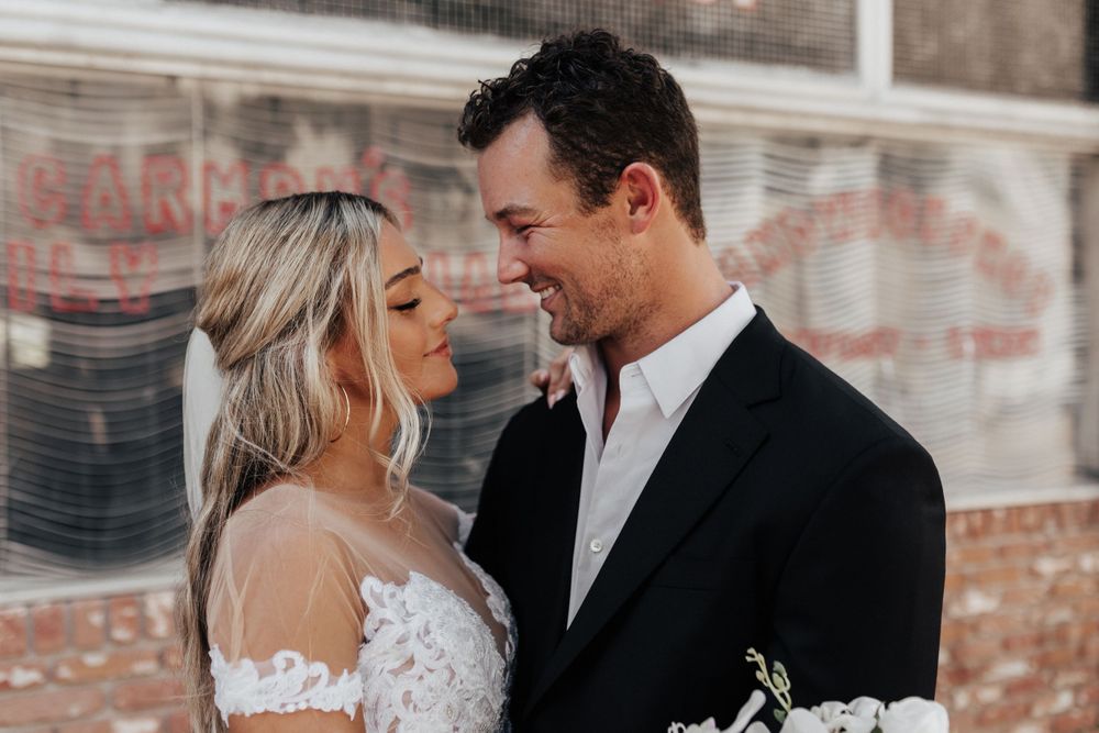 A romantic wedding portrait of a couple in formal attire sharing a tender moment together.