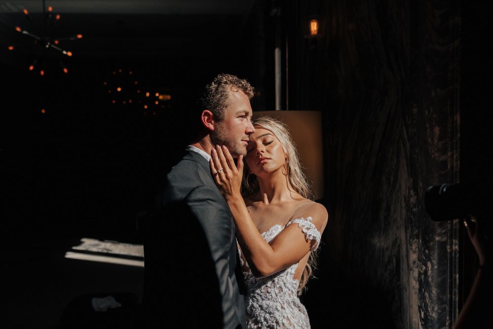 An intimate wedding dance moment captured in moody lighting with romantic ambiance.