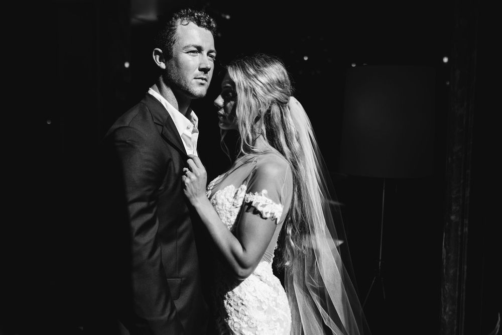 A dramatic black and white wedding portrait showcasing an intimate emotional moment.