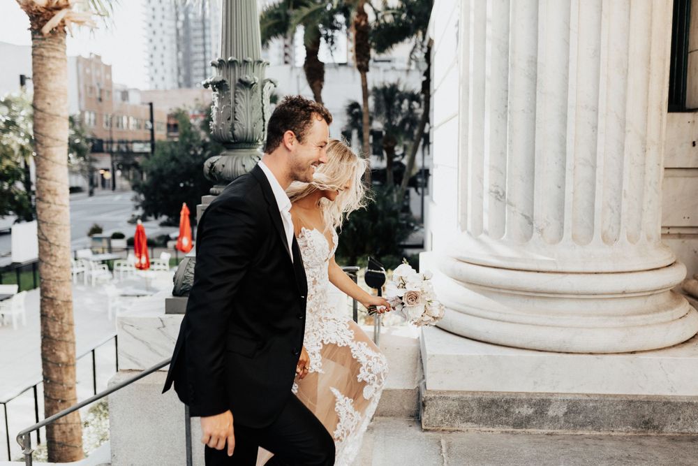 A romantic moment captured between a couple on classic architectural steps.