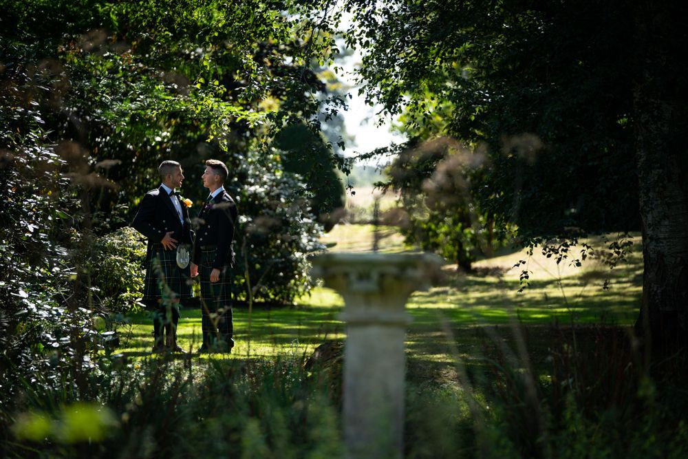 two grooms in the sunken garden