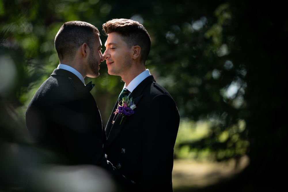two grooms in the shaded secret garden