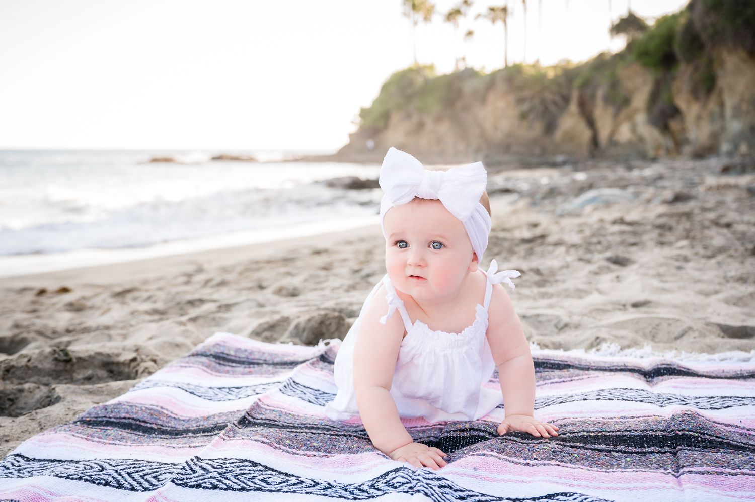 Image of a one year old baby girl on the beach in Laguna Beach, California