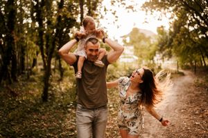 A candid moment of family joy and laughter captured during a sunset walk.