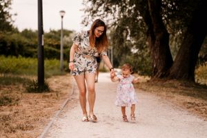 A leisurely walk along a park pathway during golden hour.