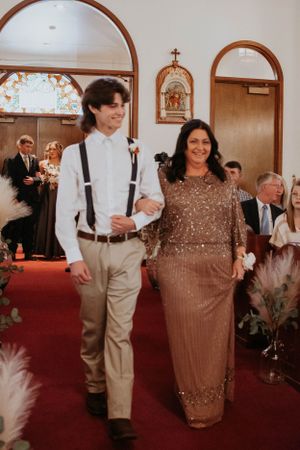 Church wedding procession featuring decorative arches and religious artwork on the walls.