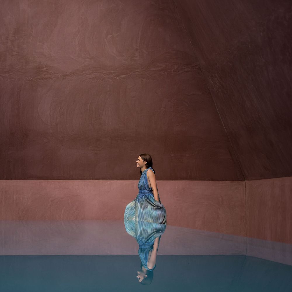 Kirstie Fitzpatrick from 7 News Regional, wearing a blue Dress and walking through an art display in Canberra.