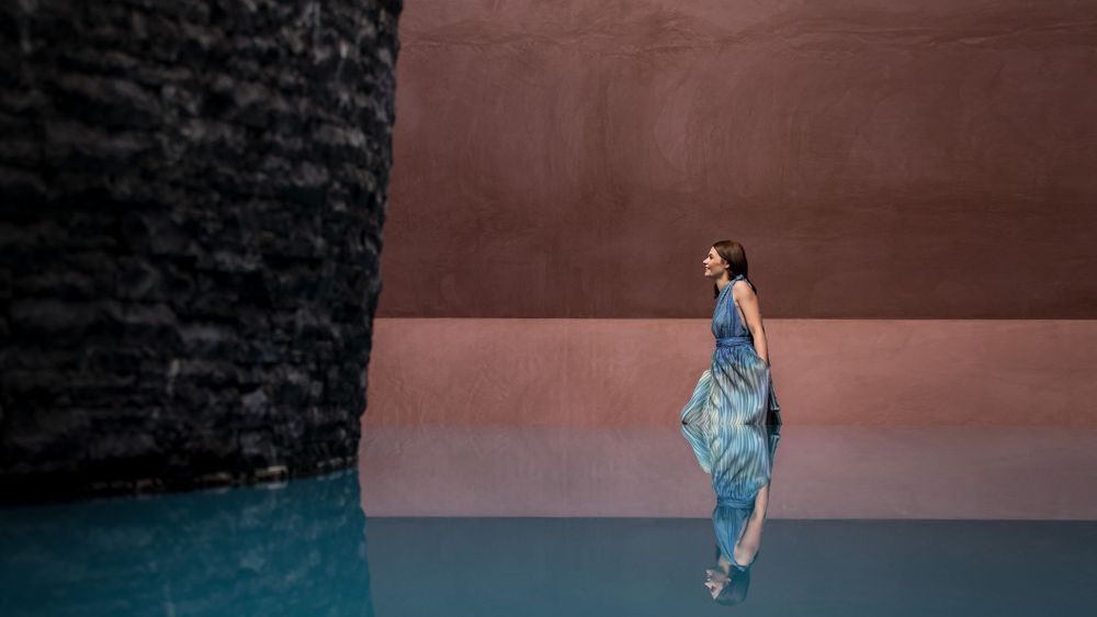 Kirstie Fitzpatrick from 7 News Regional, wearing a blue Dress and walking through an art display in Canberra.