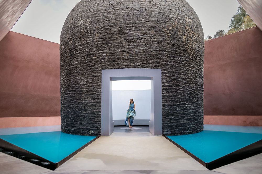 Kirstie Fitzpatrick from 7 News Regional, wearing a blue Dress and walking through an art display in Canberra.