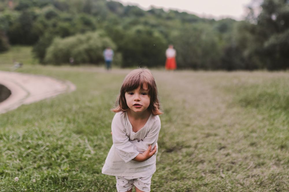Candid outdoor portraits taken in a serene natural setting with soft lighting.
