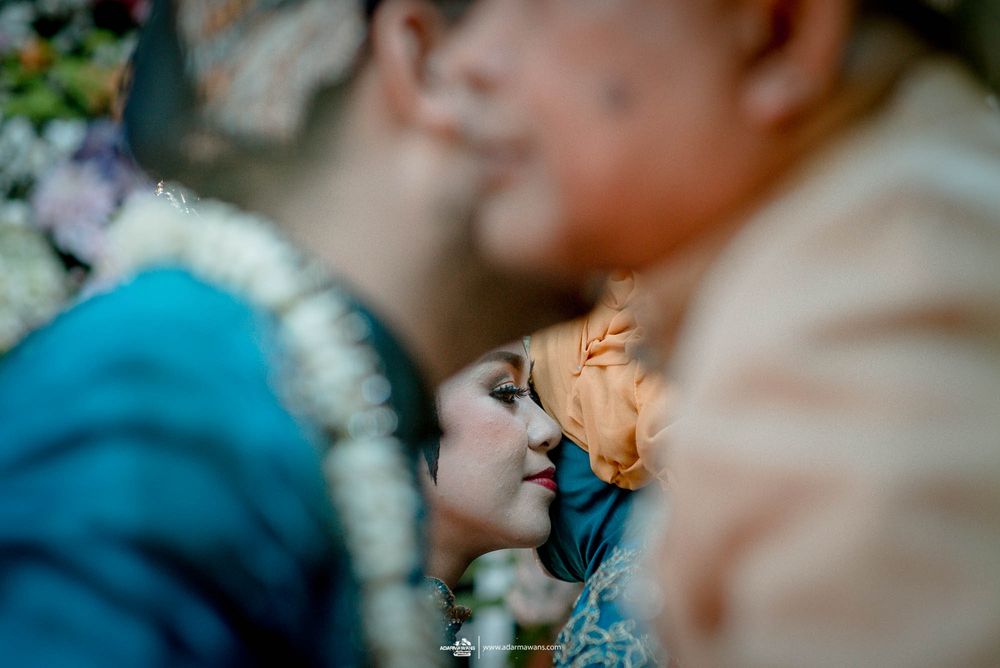 Soft focus shot of traditional Indonesian wedding ceremony moment.