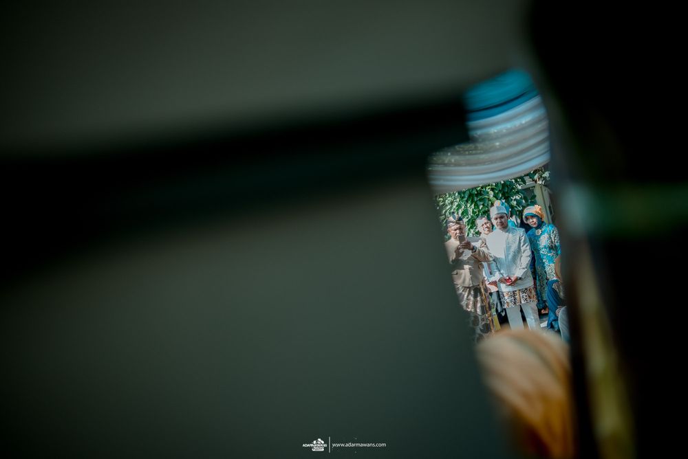 Blurred photograph being held showing group gathering.
