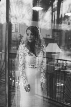 Classic black and white bridal portrait showing elegant lace wedding gown.