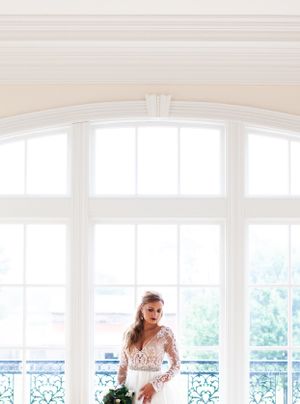 Bright interior with arched windows and ornate architectural details.