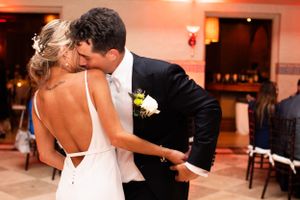A romantic dance moment captured during a wedding reception with warm lighting.
