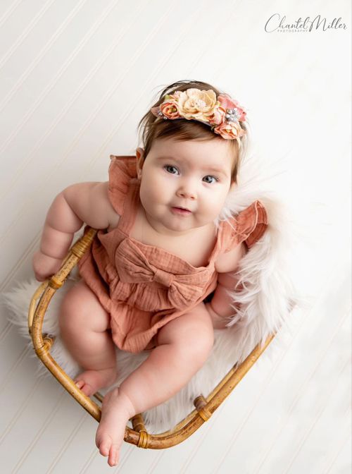 baby girl in basket smiling