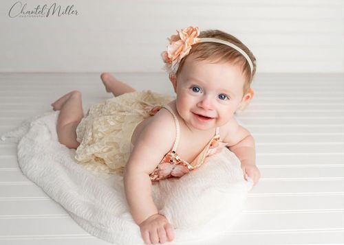 baby on tummy smiling