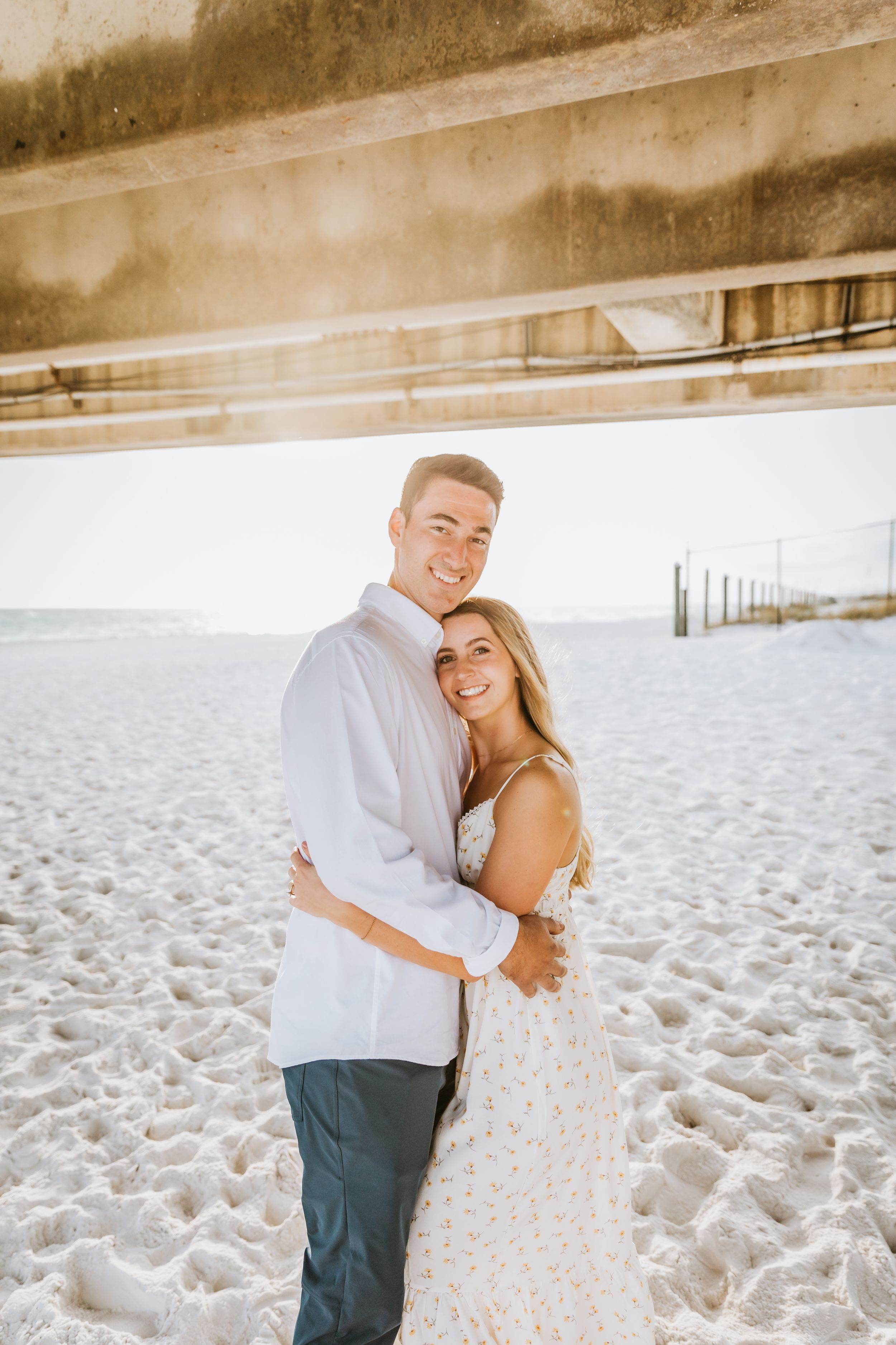 A romantic beach photoshoot sequence with soft lighting and sandy backdrop.