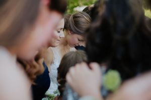 An intimate moment captured during an outdoor wedding celebration.