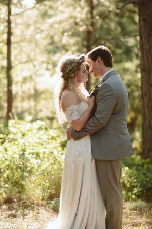 A romantic moment captured in golden sunlight filtering through a forest.