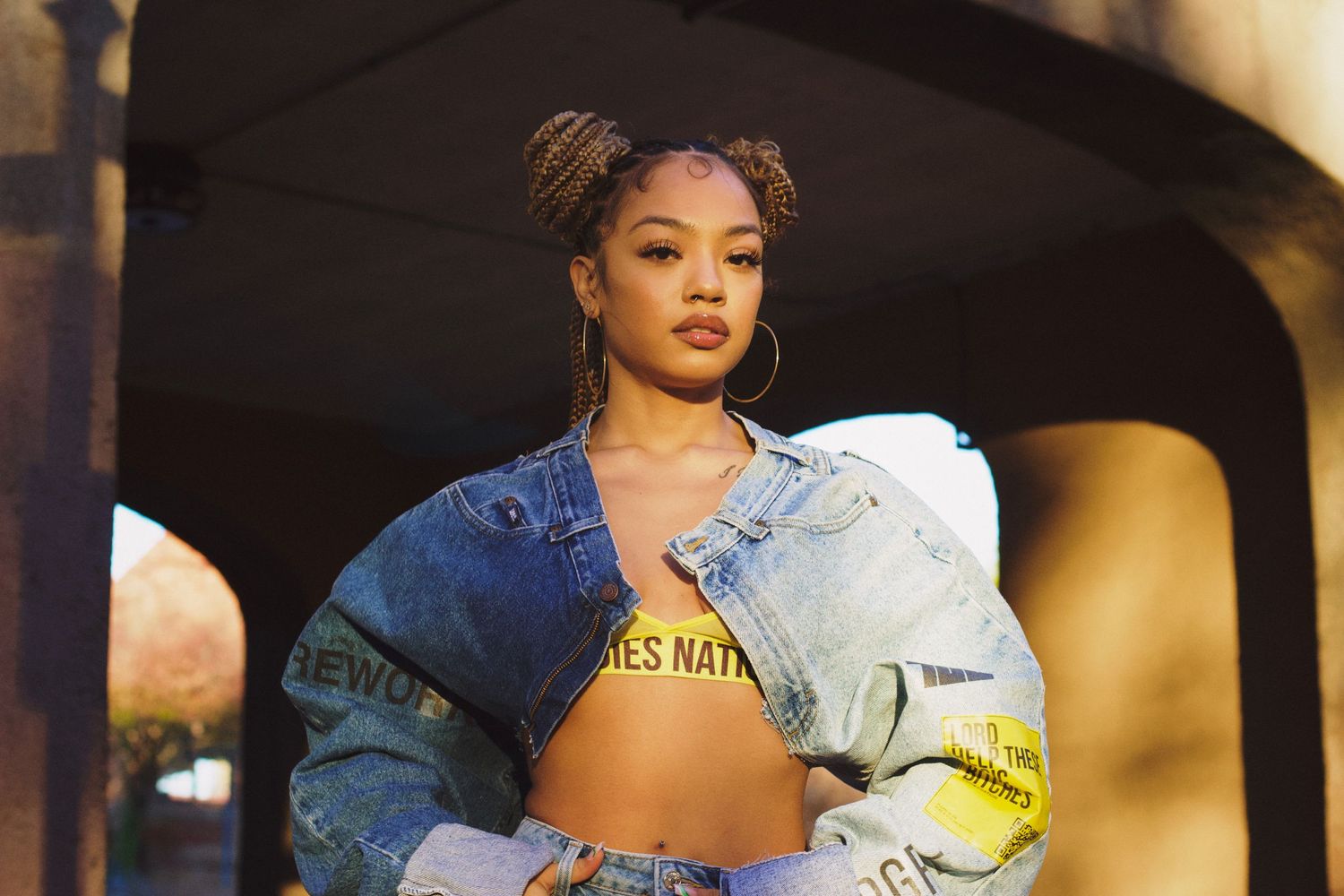 Singer/songwriter Juani modeling new denim jacket for streetwear brand Ladies Nation.