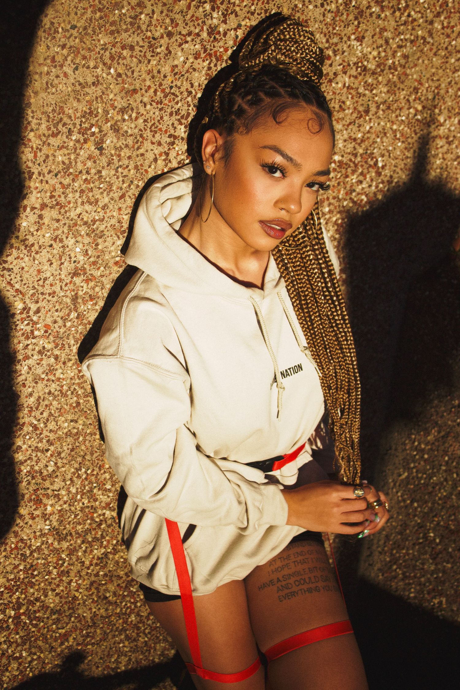 Front view of singer/songwriter Juani modeling new fashion hoody for streetwear brand Ladies Nation.