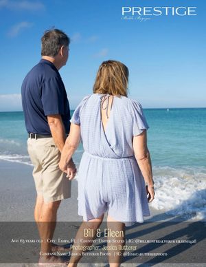 Couple in coordinating blue outfits enjoying waves on tropical beach.