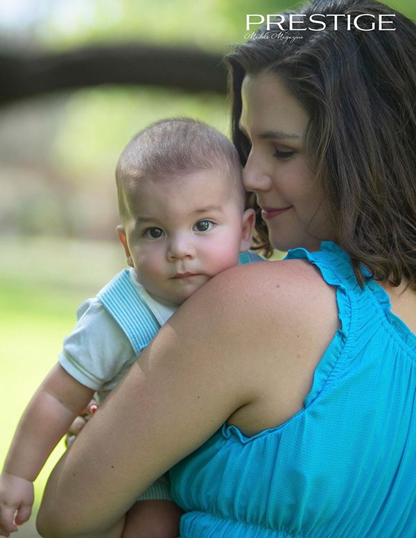 Tender moment captured between parent and baby in soft natural lighting.