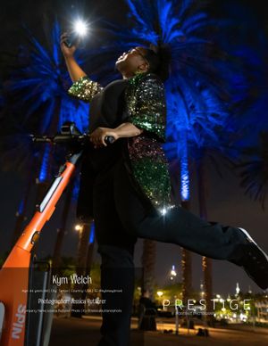 A dynamic nighttime portrait with blue-lit palm trees and glowing sparklers.