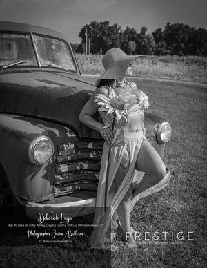 Vintage black and white photoshoot featuring classic car and romantic styling.
