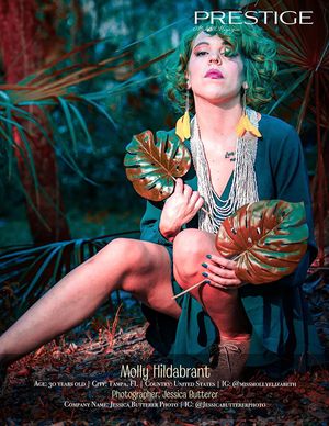 Artistic fashion model poses with tropical palm leaves in a moody photoshoot with teal and red lighting effects.