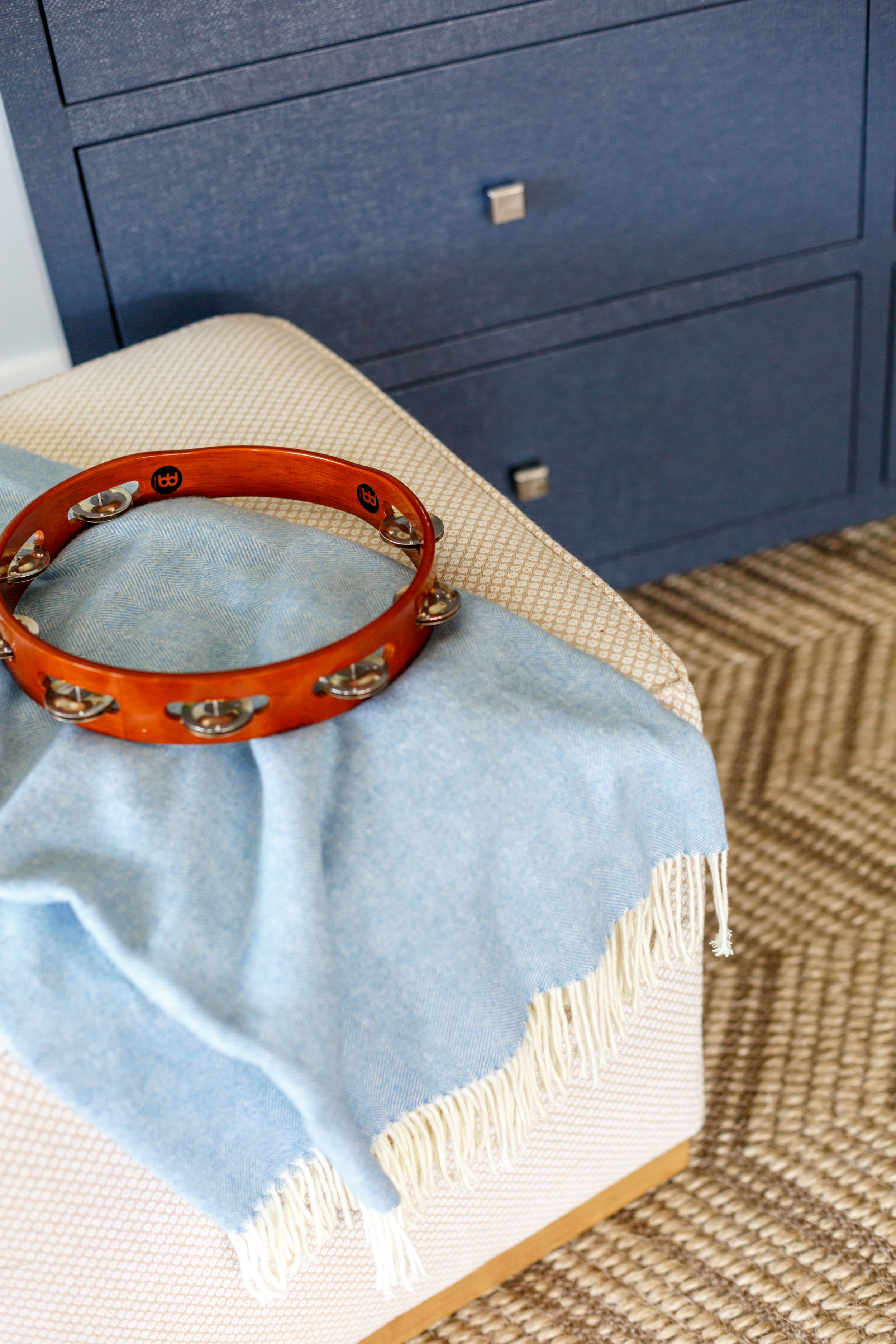 Blue upholder dressed in coastal, traditional master bedroom.