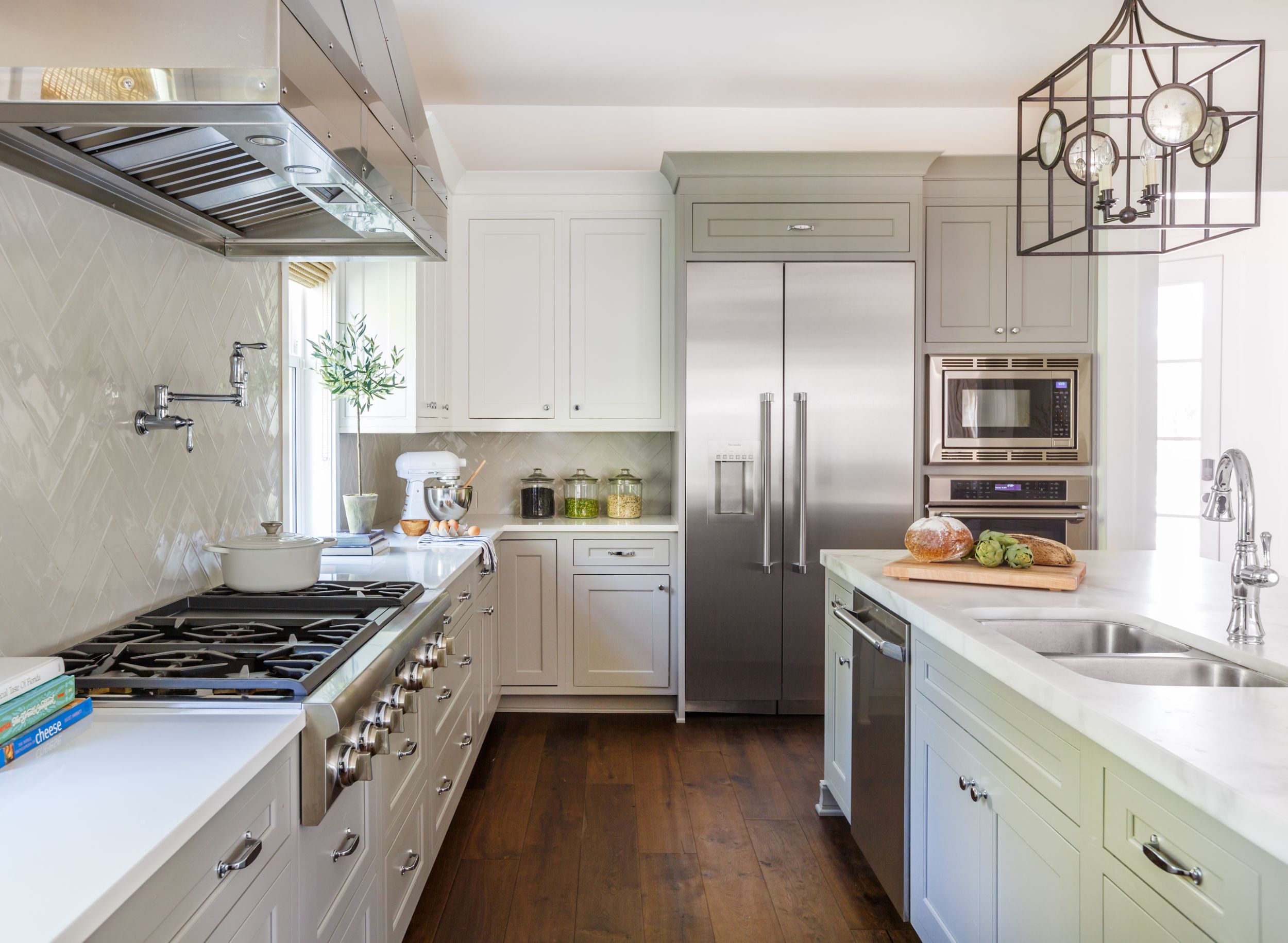 Coastal kitchen with Calcutta gold marble countertops and white cabinets.