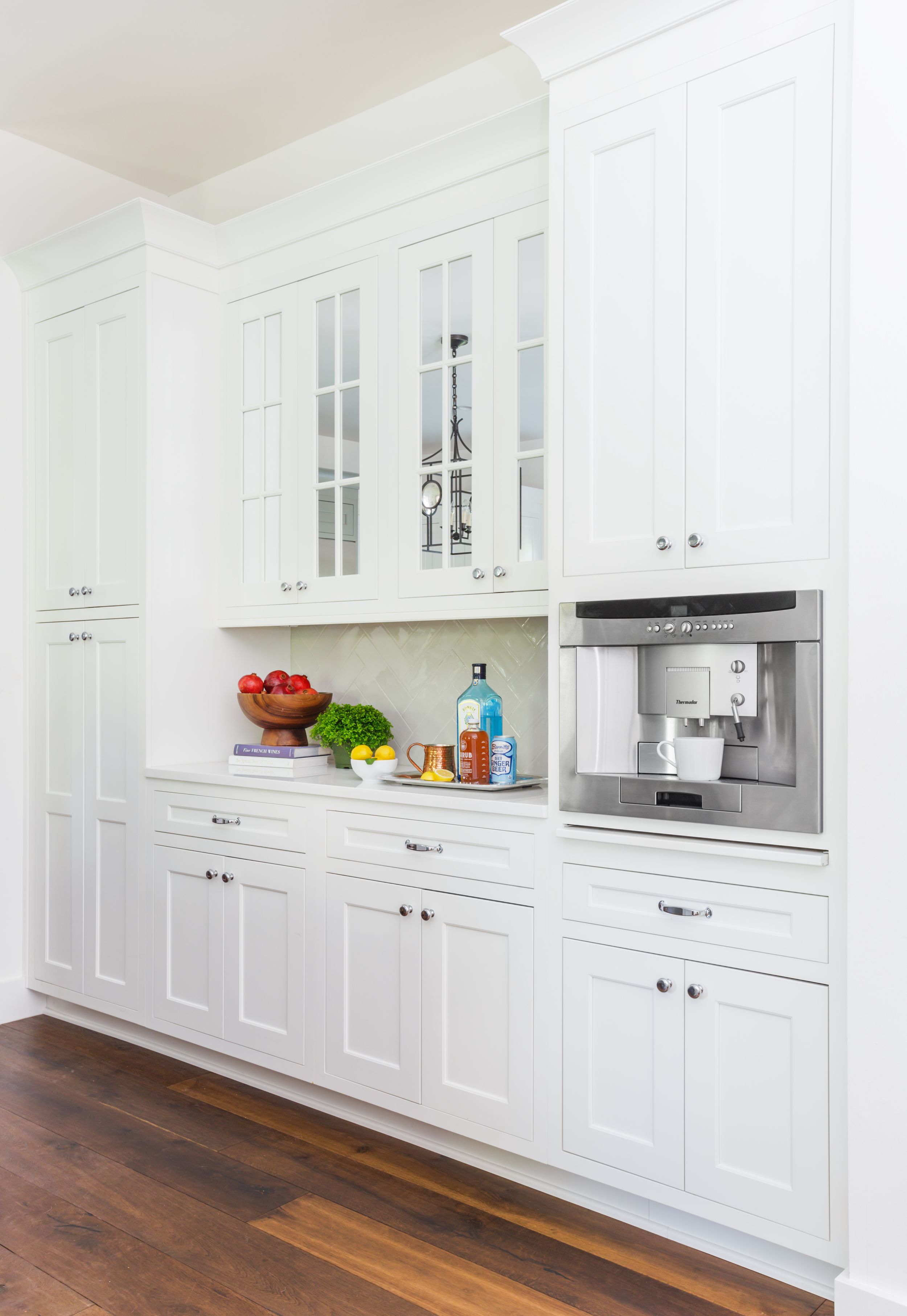 Bright, white coastal kitchen with shaker cabinets.
