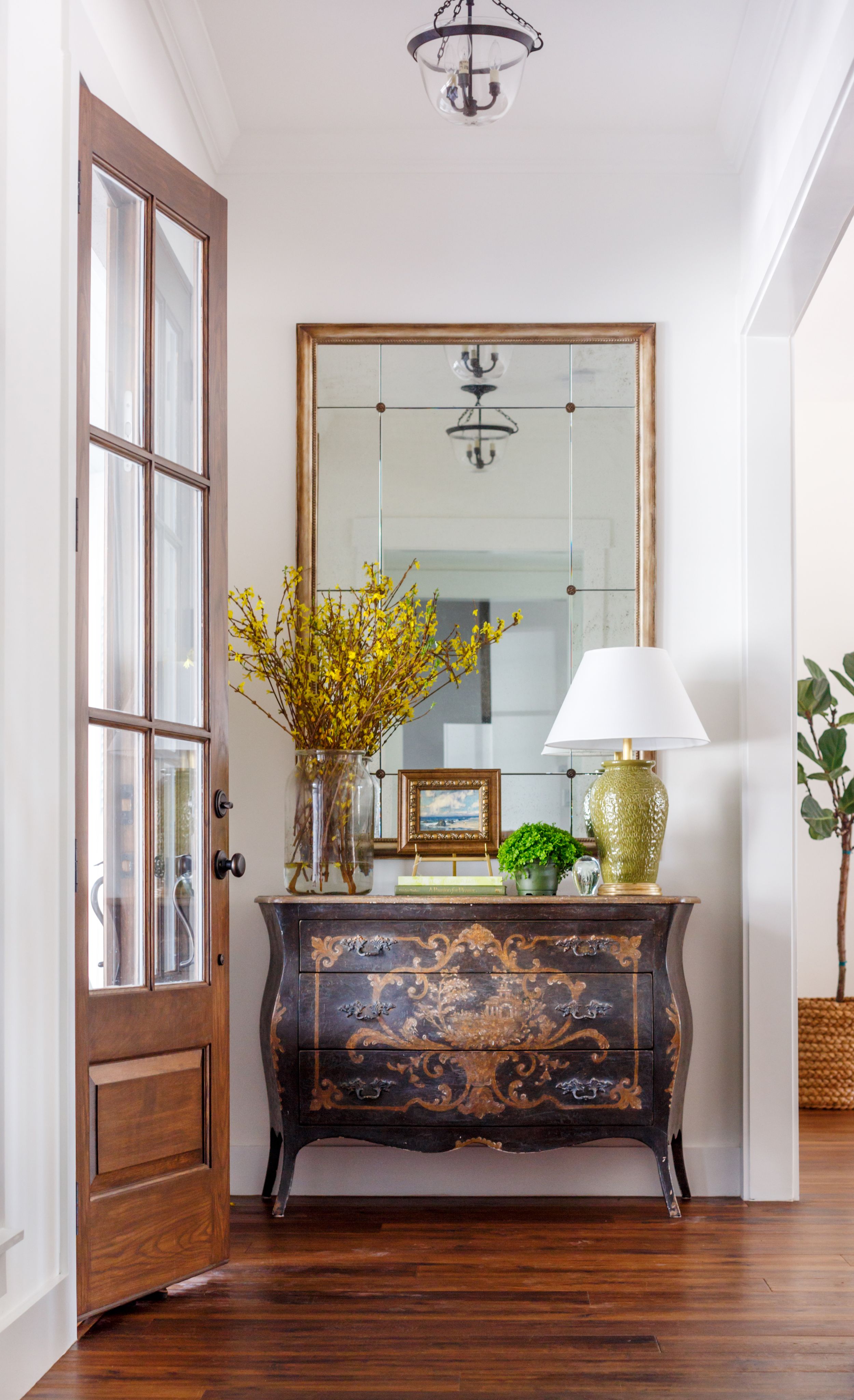 Luxury, traditional entryway with antique furniture and mirror