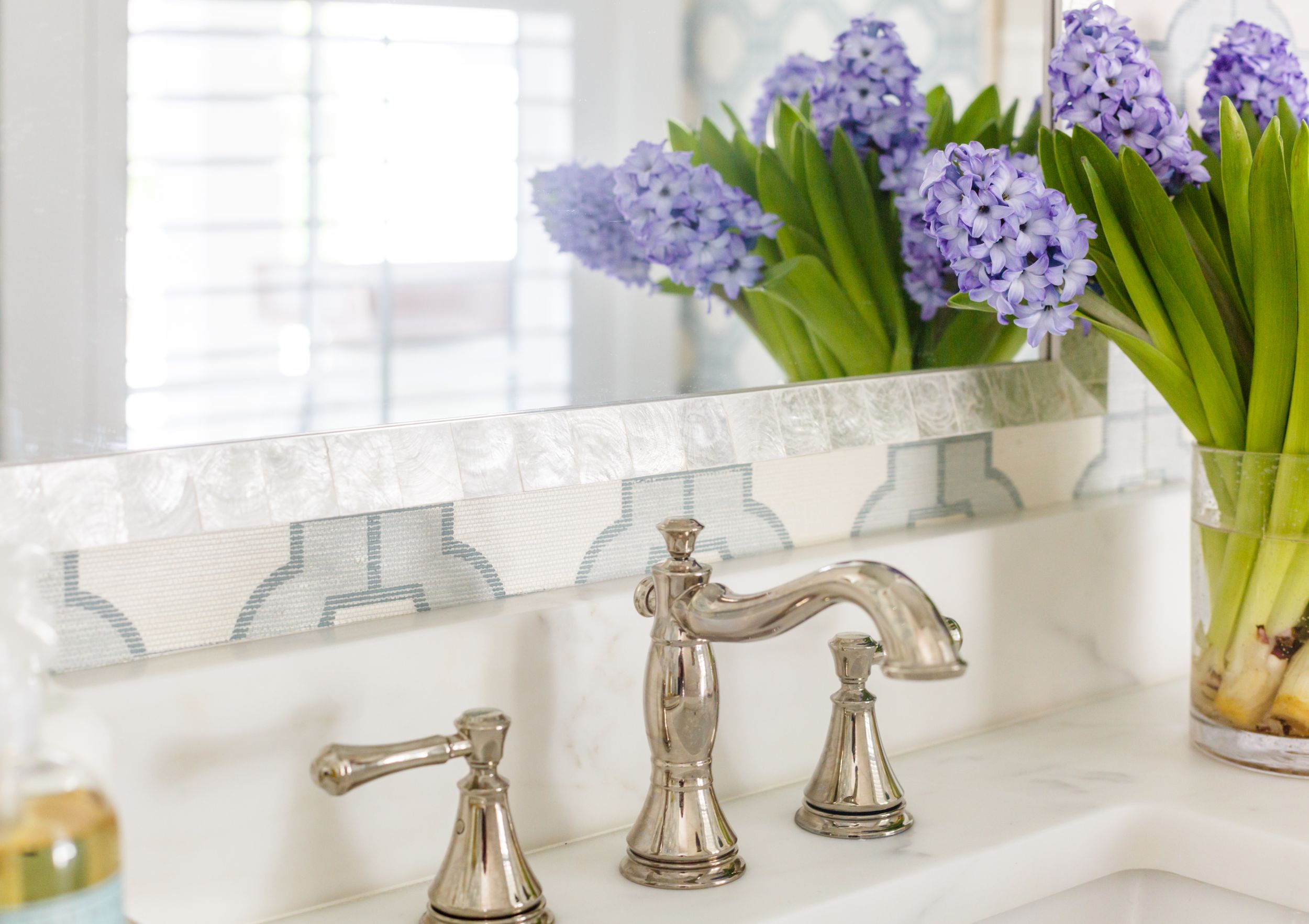 Coastal traditional bathroom with polished nickel hardware.