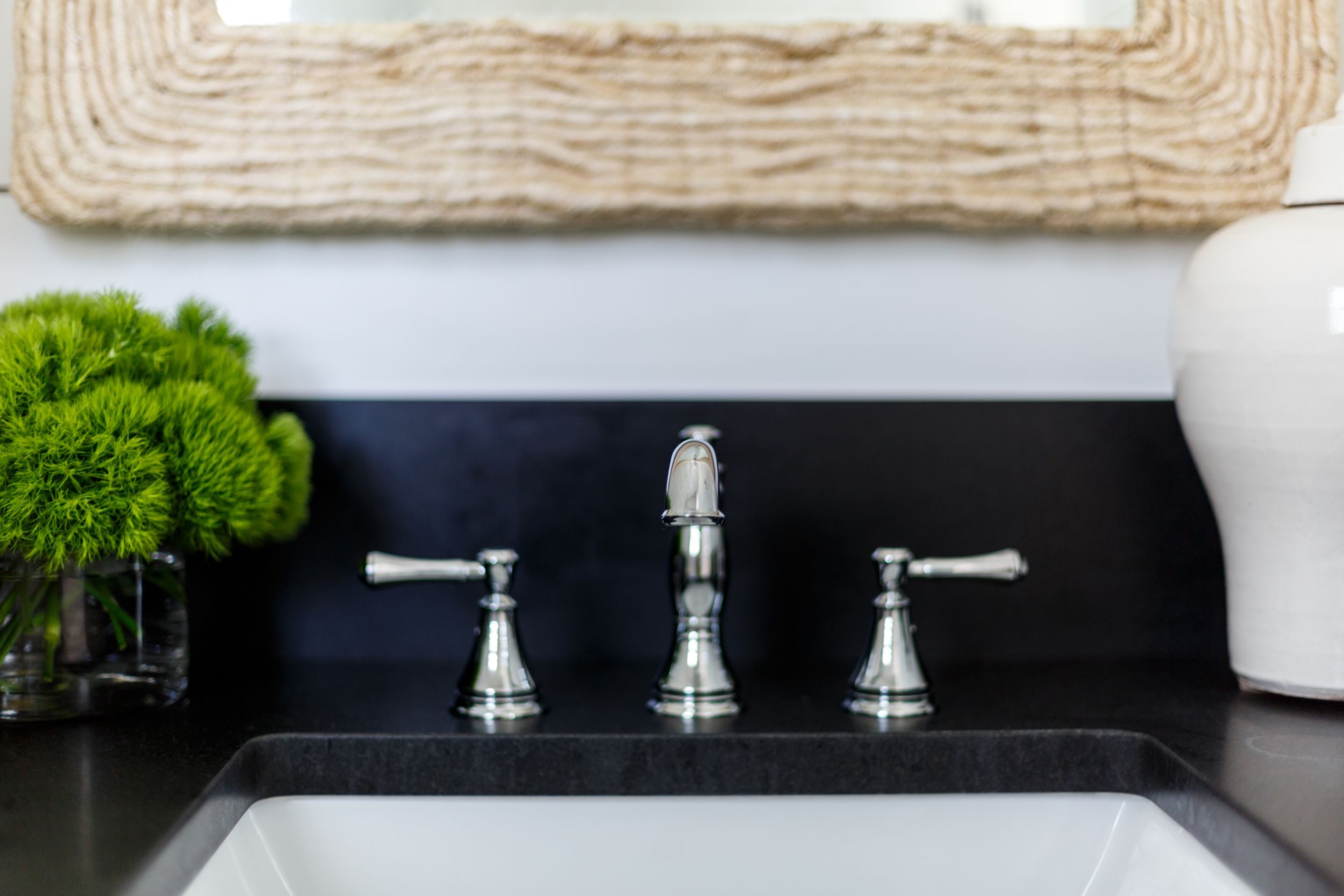 Coastal, traditional bathroom with polished nickel hardware on the sink.